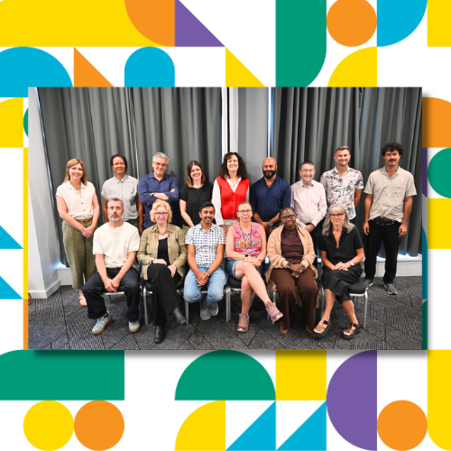 Two rows of people pose formally for a group photo.